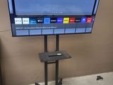a flat screen tv on a stand in a room