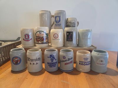 a lot of beer mugs sitting on a table