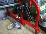 a picture of a red bike stand with tools on it