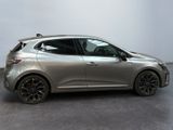 a silver car is parked in a room with a white wall