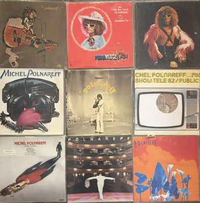 many different album covers on the wall of a room