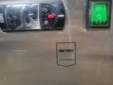 a close up of a machine with a green light on it ' s side
