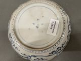 a blue and white bowl with a label on it