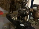 a statue of a bird sitting on top of a table