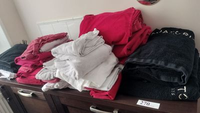a dresser with a bunch of clothes on top of it