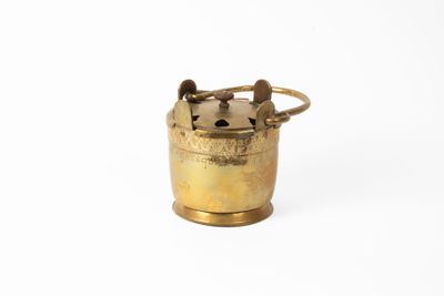 an old brass oil canister with a handle on a white background