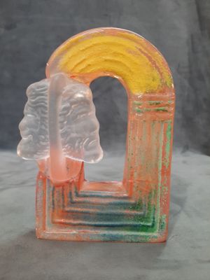 a glass sculpture of a rainbow and a cloud
