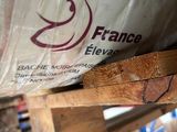 a bag of food sitting on top of a wooden pallet