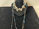 a close up of a necklace on a mannequin with blue beads