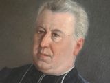 portrait of a man in a black coat with a white collar