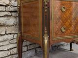 a small wooden table with a marble top on a stone floor