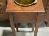 a wooden table with a metal bowl on top of it