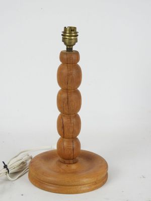 a wooden table lamp that has a cord attached to it