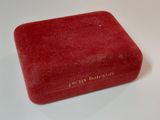 an image of a red velvet box with writing on it
