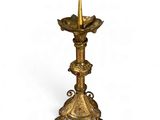 an image of a gold candle holder with a gold cone on top