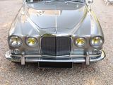 a silver car that is parked in the gravel