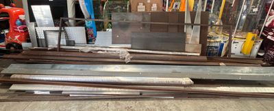 several pieces of metal are stacked on top of each other in a warehouse