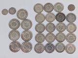 a lot of coins sitting on a white surface