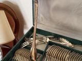 a box with silverware in it and a lamp next to it