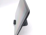 a tablet computer sitting on a stand on a white surface