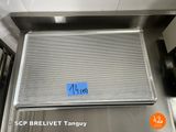 a picture of a stainless steel grill with a blue tag on it