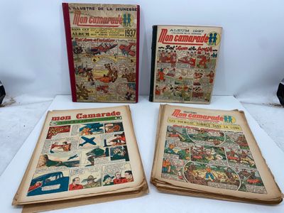 three old comic books sitting on top of a white table