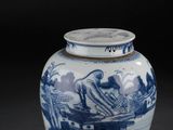 un vase bleu et blanc posé sur une surface noire