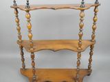 an old wooden shelf with three shelves on top of it