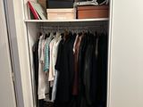 a closet with a lot of clothes in it