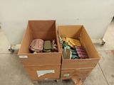 two boxes with items in them sitting on the floor