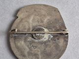 a small metal object that is on a white surface