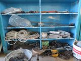 a blue cabinet filled with assorted tools and other items