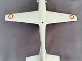 a model airplane that is sitting on a gray surface