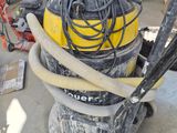 a yellow and black vacuum sitting on top of a cart