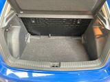 a trunk of a blue car with its doors open