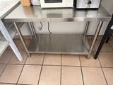 a stainless steel table with a microwave on top of it