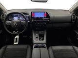 the interior of a car with a steering wheel, dashboard, and dashboard controls