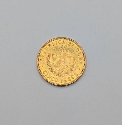 l'image d'une pièce d'or sur laquelle figurent des armoiries