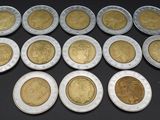 a close up of a bunch of coins sitting on top of a table