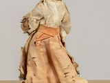 two dolls that are standing next to each other on a table