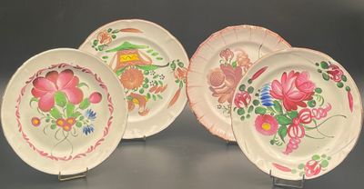 three plates with floral designs on them on a table