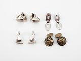 three pairs of silver earrings and a pair of silver ear clips