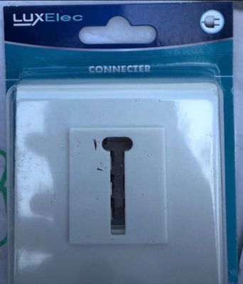 a white light switch in a package on a table