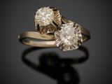 a close up of two diamond rings on a black surface