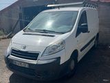 a white van parked in front of a building