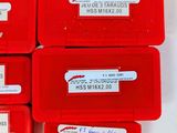 six red plastic boxes with labels on them sitting on top of a white surface