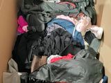 a cardboard box filled with clothes and other items