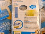 a package of cat grooming products sitting on top of a pile of boxes