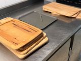 two wooden cutting boards on the counter in the kitchen