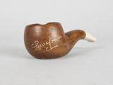an old pipe with writing on it sitting on a table